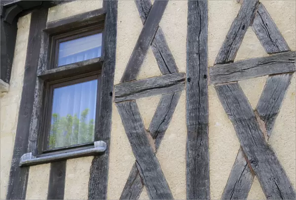 Europe, France, Burgundy, Nievre, Nevers. Medieval half-timbered house with glass window