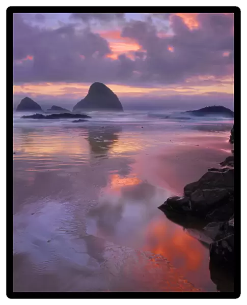 USA, Oregon, Oceanside. Sunset on beach and sea stacks