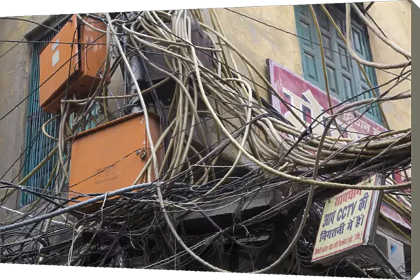 New Delhi, mass of wires for electronics and telecommunications strung between businesses