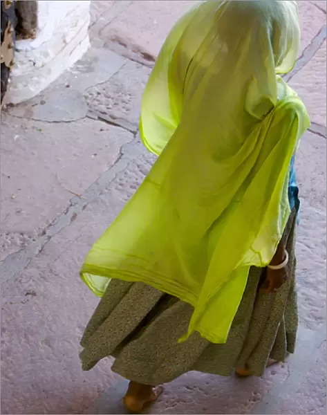 Rajasthan indian, A woman in a beautiful green scarf walking away