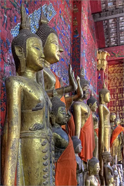 Southeast Asia, Laos, Luang Prabang. Statues of Buddha inside Buddhist temple. Credit as