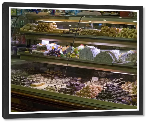 Europe, Italy, Venice. Glass display case filled with pastries and cookies. Credit as