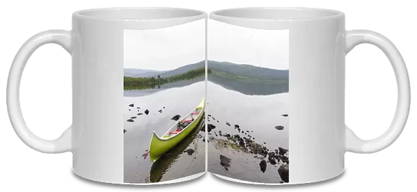 Sweden, Norrbotten, Torne River. Canoe in tranquil waters
