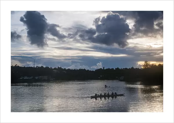 Local people training for the rowing championship in the island of Yap at sunset