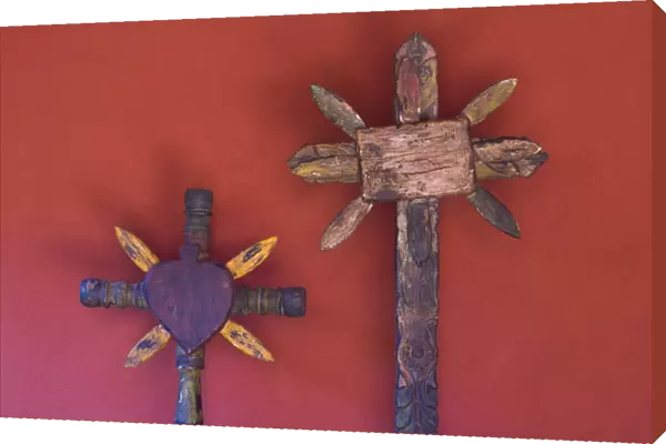 Mexico, San Miguel de Allende. Close-up of two wooden crosses against red wall. Credit as