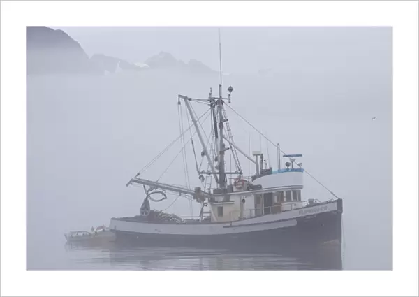 North America; USA; Alaska; Valdez; Fishing Boat in Fog with Mountains in Background