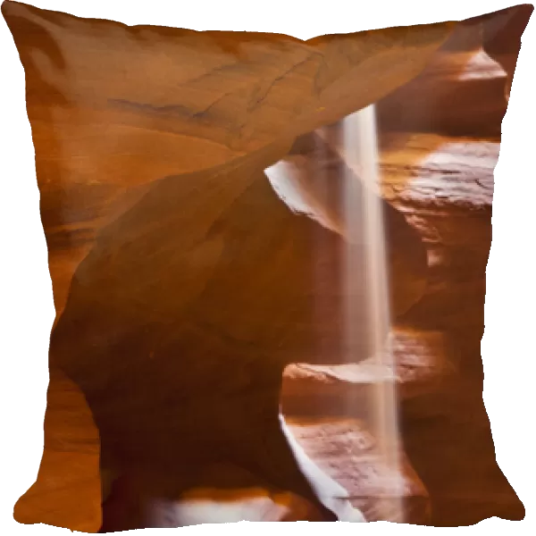 USA, Arizona, Upper Antelope Canyon. Falling sand mimics light ray amid sandstone formation