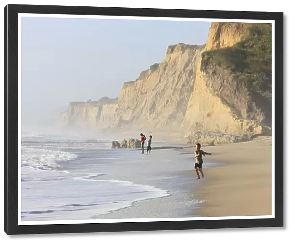 Kids playing on beach. Santa Cruz coast, California, US. Hazy day at the Beach
