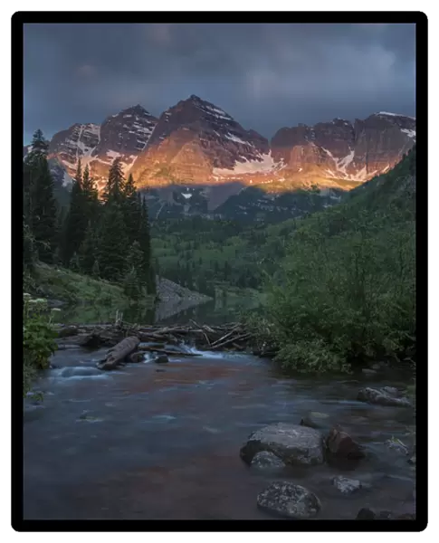 USA, Colorado, Maroon Bells State Park. Summer sunrise storm clouds on Maroon Bells mountains