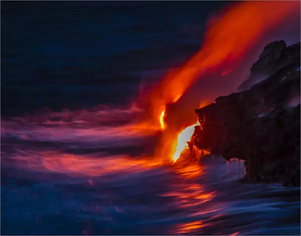 USA, Hawaii, The Big Island, Kilauea. Molten lava flowing into ocean at night. Credit as