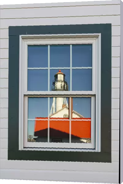Whitefish Point Lighthouse reflected in window, the oldest operating light on Lake Superior