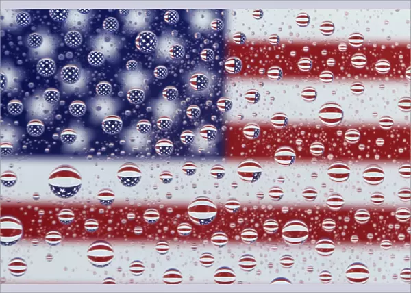 WA, Redmond, American flag; reflected in water drops