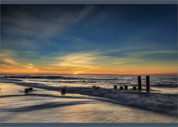 USA, New Jersey, Cape May National Seashore. Sunrise on winter shoreline. Credit as