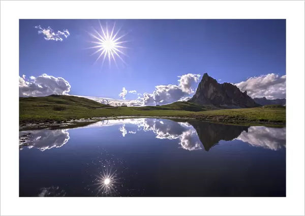 Italy, Dolomites, Giau Pass. Sun reflection in mountain tarn