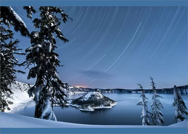 USA, Oregon, Crater Lake National Park. Star trails over Crater Lake and Wizard island in winter