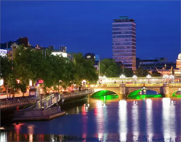 Europe, Ireland, Dublin. Ha Penny Bridge and River Liffey lit at night
