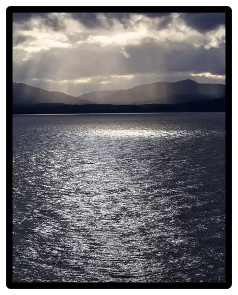 Chile, Patagonia, Strait of Magellan. Tierra del Fuego, rays of sunshine over the fjords