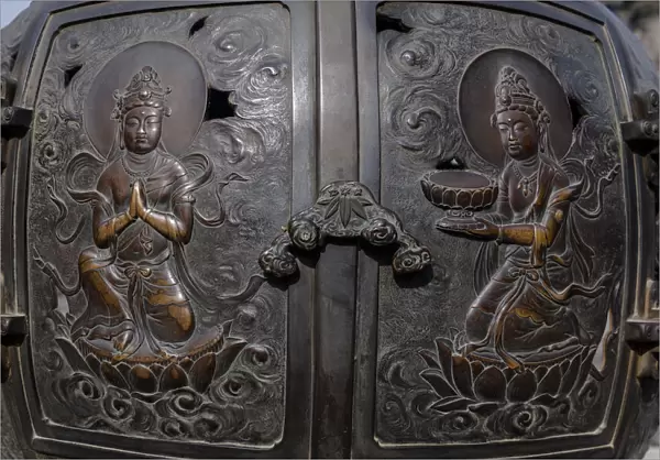 The ornate, engraved bronze doors to the outdoor incense burner of the Daibutsu, Kamakura
