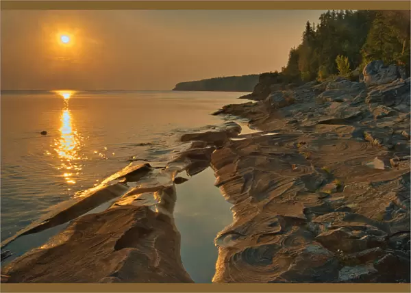 Canada, Ontario, Bruce Peninsula National Park. Sunset on limestone rock