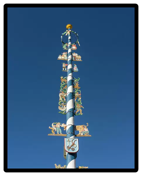 Traditional Bavarian maypole (Maibaum). Village Schliersee in the Bavarian Alps, Bavaria