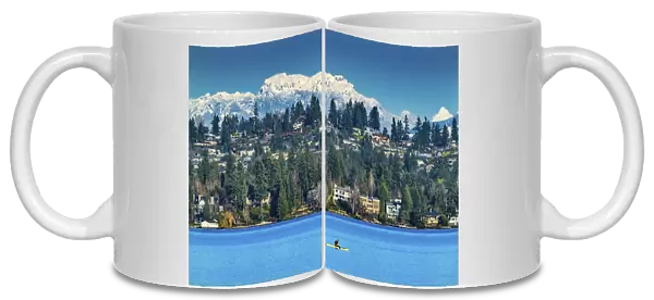 Yellow canoe and houses, Lake Washington and snowcapped Cascade Mountains, Bellevue