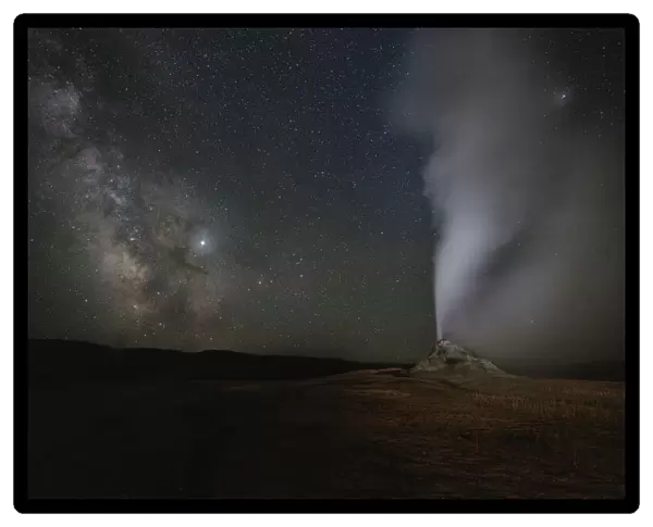 USA, Wyoming, Yellowstone National Park. Milky Way above erupting White Dome Geyser
