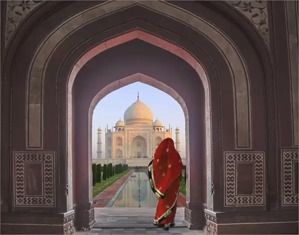 India, Agra, Taj Mahal. Composite of woman in archway facing mausoleum