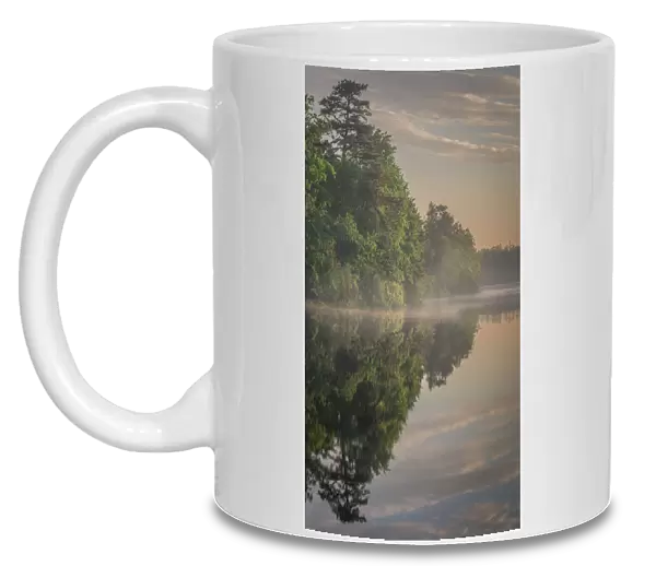 USA, New Jersey, Pinelands National Reserve. Sunrise reflections in lake