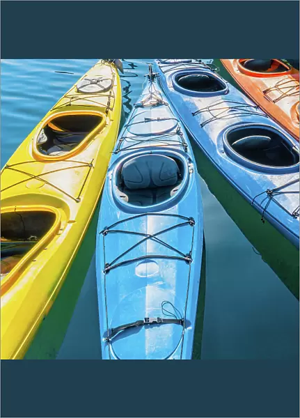 Four colorful kayaks positioned in an array