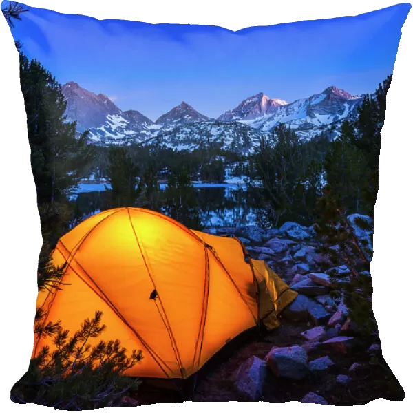 Yellow dome tent glowing at night in Little Lakes Valley, John Muir Wilderness, California, USA