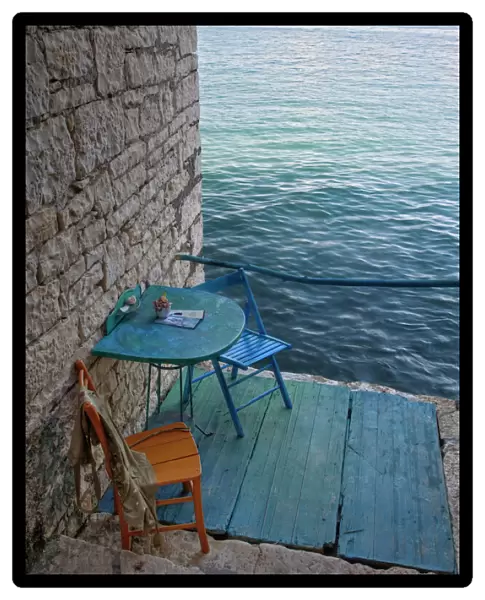 Oceanside seating for two at tiny outdoor cafe, Rovigno, Croatia