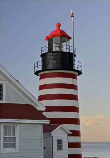 USA, Maine, Lubec. West Quoddy Head Lighthouse, Quoddy Head State Park, near sunset