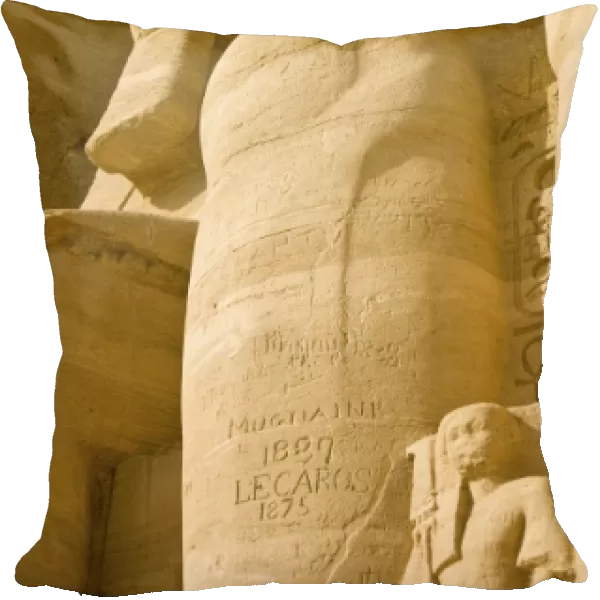 Egypt, Aswan. 19th century grafitti on Colossus of Ramses II at entrance of Abu Simbel