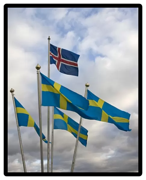 Iceland. The national flag of Norway flies above a grouping of Swedens National flags