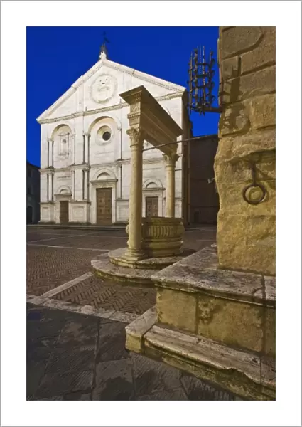 Italy, Tuscany, Pienza. Cathedral facade and the Palazzo Piccolomini at dusk