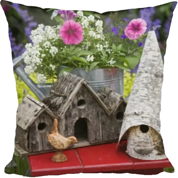 Close-up of bird houses and planter on garden table