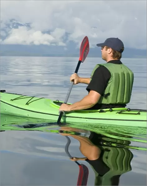 North america, USA, AK, Inside Passage. Kayaker enjoys brilliant calm day (MR)