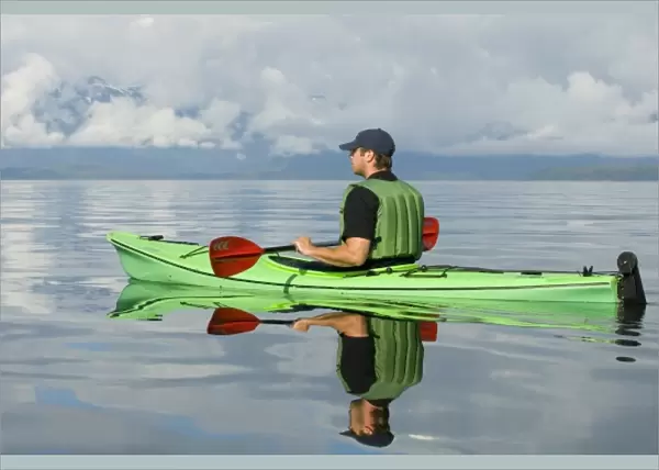 North America, USA, AK, Inside Passage. Kayaker enjoys brilliant calm day (MR)