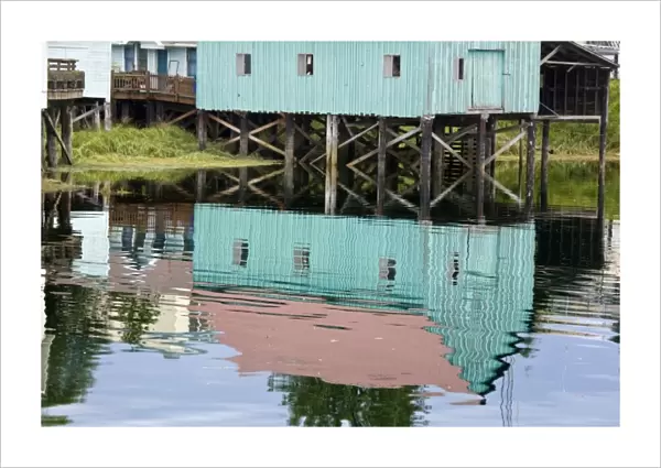 USA, Alaska, Petersburg. Water reflections of buildings in Hammer Slough