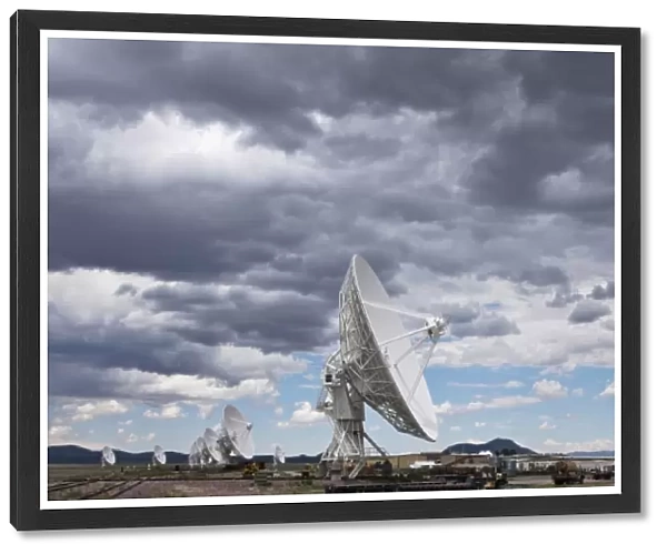 USA, New Mexico, Socorro, Radio telescopes under summer storm clouds at VLA Radio