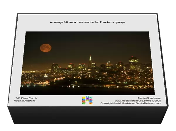 An orange full moon rises over the San Francisco cityscape