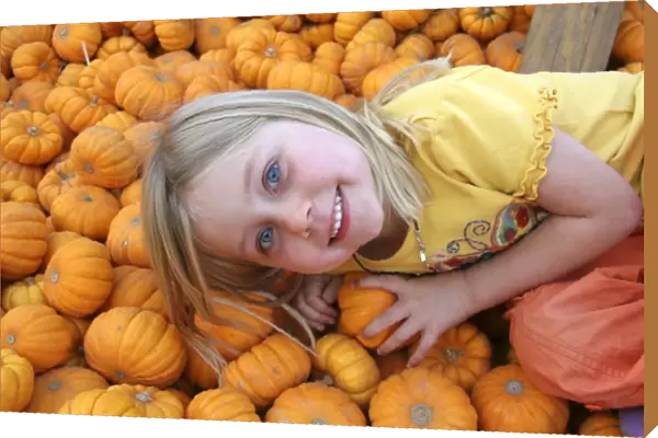 USA, California, Encinitas. A young girl enjoys a local pumpkin patch carnival