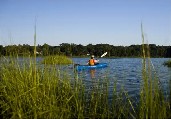 A woman kayaks in the Black Hall River near the mouth of the Connecticut River in Old Lyme