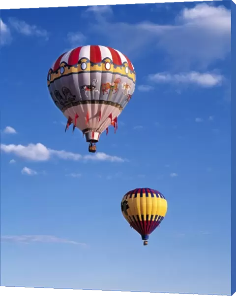USA, Idaho, Teton Valley. Colorful hot-air balloons are suspended in air above Teton