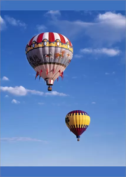 USA, Idaho, Teton Valley. Colorful hot-air balloons are suspended in air above Teton