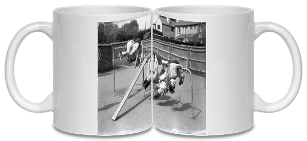 Children upside down on climbing frame, Lancastrian Infants School, Chichester, May 1956