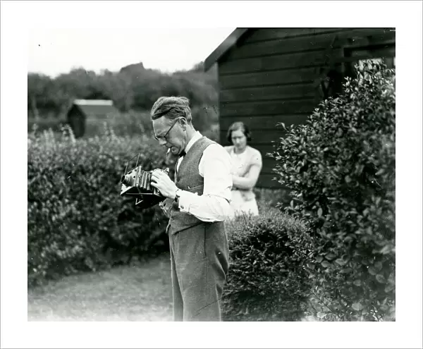 George Garland in a garden with his camera, September 1938