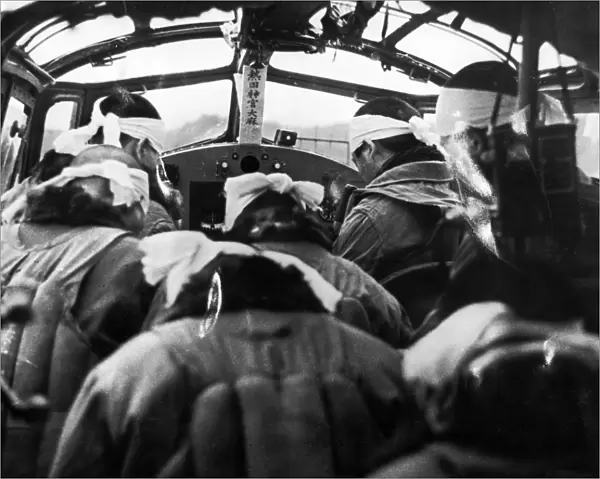 Japanese pilots bow their heads in a Shinto ceremony before take-off, at the Nicobar Islands in the South Pacific. Photograph, Summer 1942