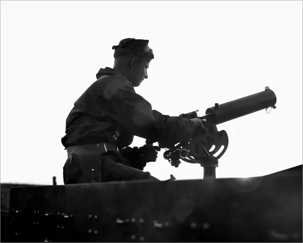 A machine gunner engaged in mock battle during U. S. Army war maneuvers at Fort Benning, Georgia, 16 April 1940