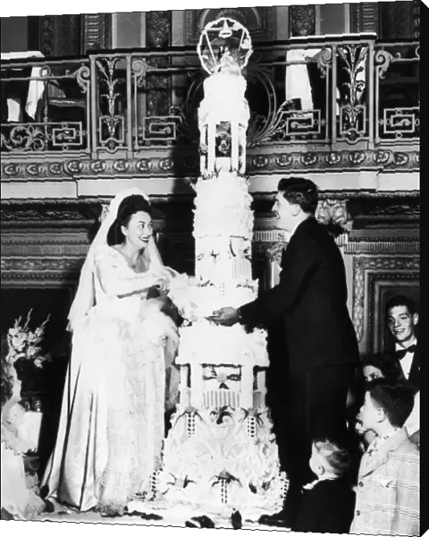 Mr. and Mrs. Thomas Tarallo cutting their wedding cake for 700 guests at a Chicago hetel, April 1947